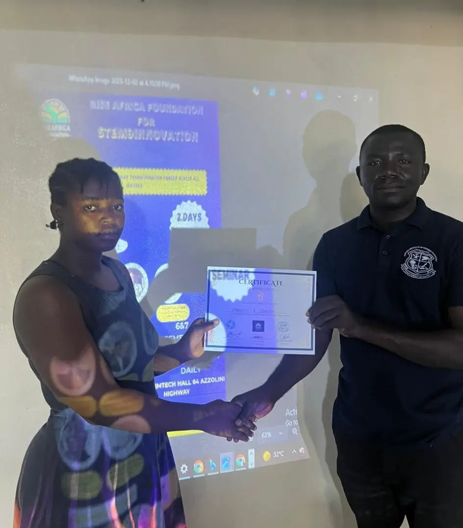 A participant receives her certificate